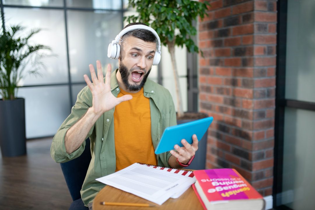 emotional student having video lesson in foreign language