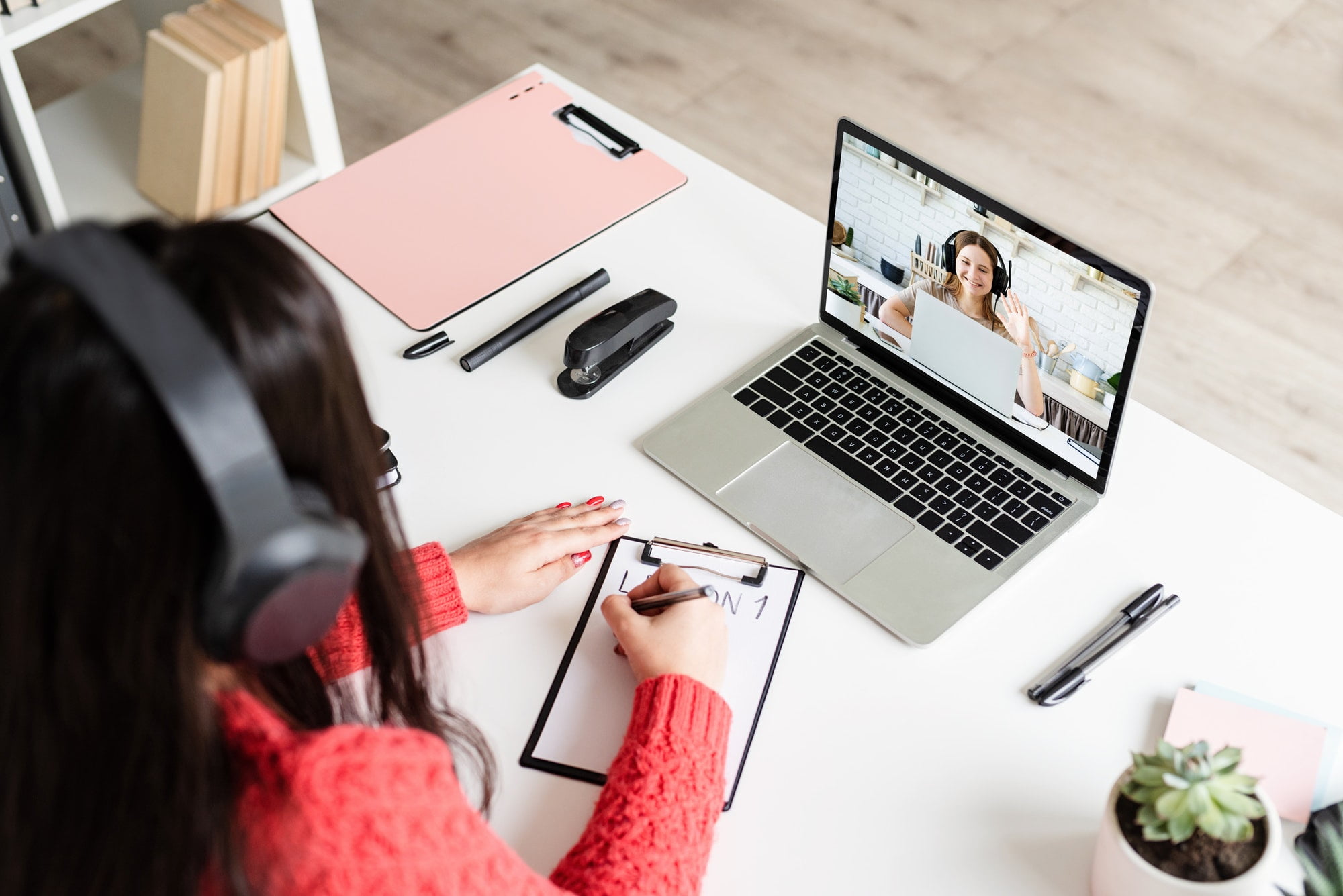 Young latin woman in black headphones teaching english online