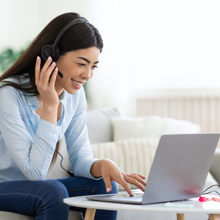 Asian-woman-studying-foreign-languages-online-with-laptop-and-headset-at-home. Jpg